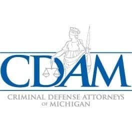 Logo for Criminal Defense Attorneys of Michigan featuring the acronym "CDAM" and a Lady Justice figure with scales and sword.